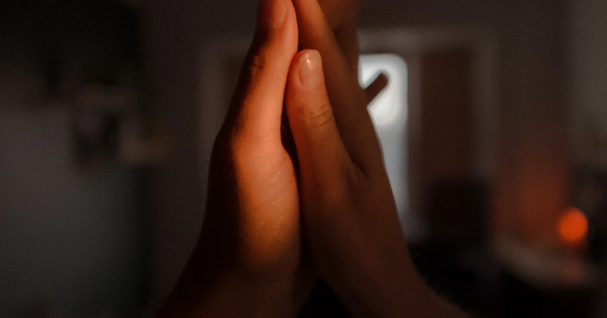 persons hand doing peace sign