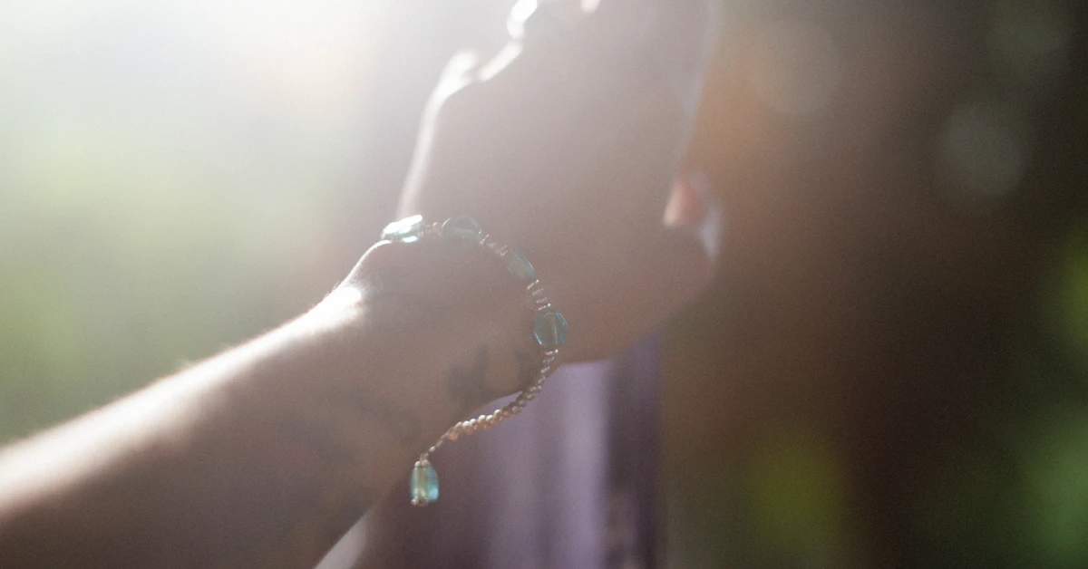 a person's hand with a ring on it